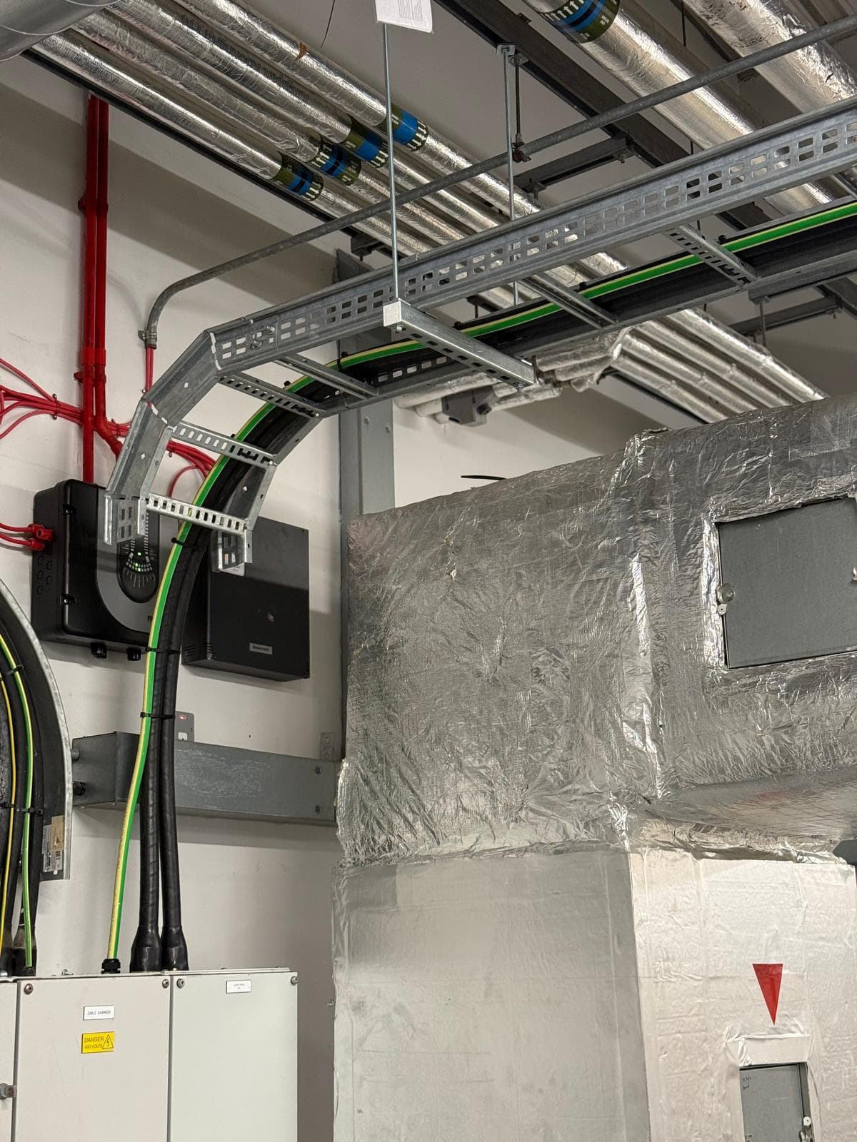 Cable tray, containment and building-services electrical work in a commercial plant room
